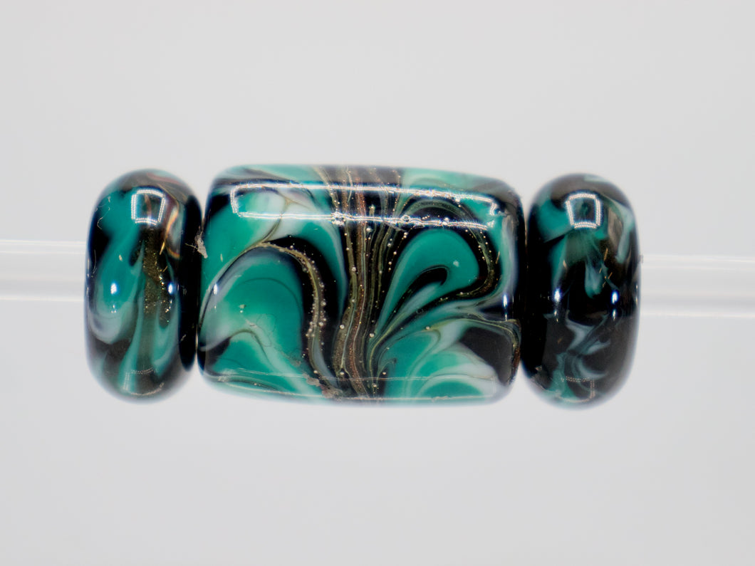 a glass bead with a swirl design on it