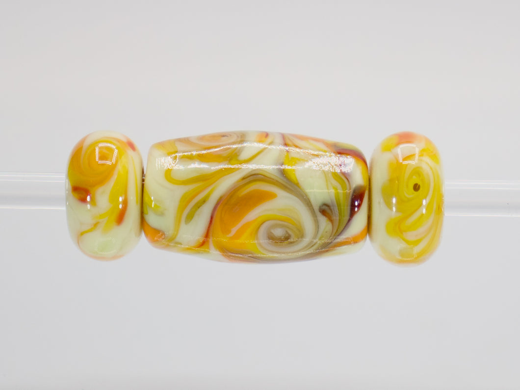 a glass bead with a swirl pattern on it