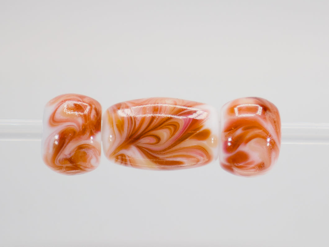 a group of three glass beads sitting on top of a table