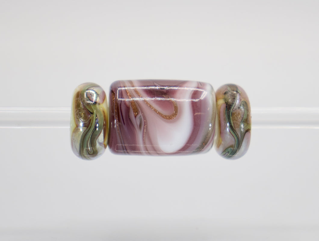 a glass bead with a design on it